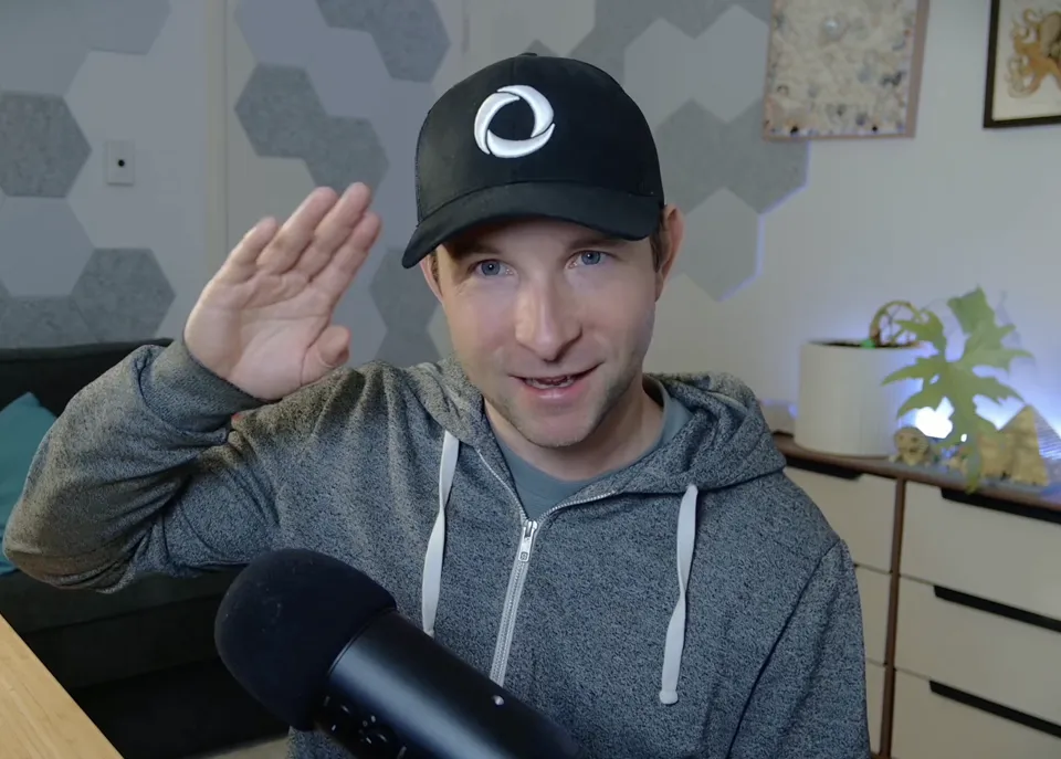 Mike waving goodbye in his Convex cap